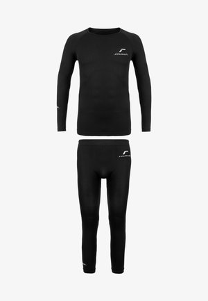 Lasten musta uimapuku, jossa on pitkät hihat ja tiukat leggingit. Suunnittelussa on hienovaraisia brändäyselementtejä ja uritettuja tekstuuriaksentteja.