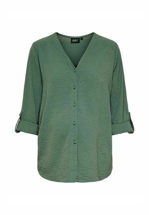 Blusa verde textured con scollatura a V, bottoni frontali e maniche arrotolate. Realizzata in tessuto leggero, presenta una vestibilità morbida.