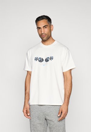 White cotton t-shirt with graphic design featuring blue accents and abstract shapes on the front. Relaxed fit, short sleeves, crew neck.