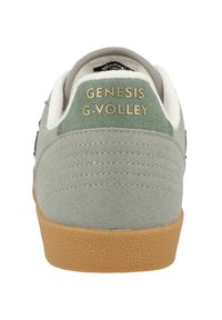 Green suede sneaker with a textured gum sole, featuring a white fabric collar and "GENESIS G-VOLLEY" in gold lettering on the heel.