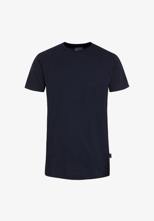 Camiseta lisa negra de manga corta y cuello redondo, con etiqueta de la marca Jockey en el interior del cuello y pequeña etiqueta lateral, mostrada sobre fondo blanco.