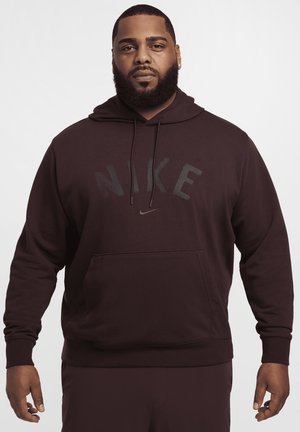 Dark burgundy Nike hooded sweatshirt with large logo, front pocket, and drawstrings. Made from soft fabric, featuring ribbed cuffs and hem.