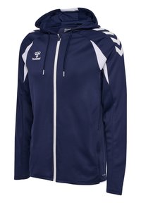 Sweat à capuche bleu marine zippé avec des bandes chevrons blanches sur les épaules, des panneaux latéraux blancs, une capuche à cordon et le logo hummel sur la poitrine.