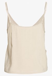 Débardeur en coton beige clair avec fines bretelles réglables, coupe décontractée et bas proprement ourlé. Détail notable avec un bouton sur le côté.