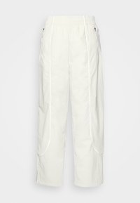 Vita, avslappnade byxor i lätt tyg med elastisk midja, sidofickor och kontrasterande piped-detaljer.