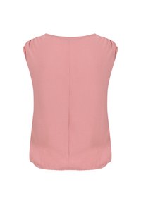 Blouse rose pâle à manches courtes avec un col rond et une couture centrale dans le dos, présentée sur un fond blanc uni.