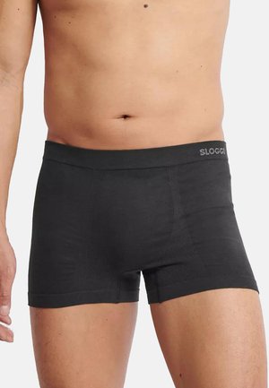Svart bomullsboxer med en tajt passform, med en elastisk midjeband märkt "SLOGGI" och synliga sömdetaljer.