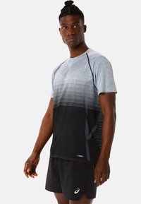 Men's athletic shirt in gradient gray and black fabric, featuring short sleeves, textured patterns, and moisture-wicking properties.