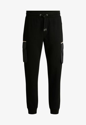Jogging pants noirs en tissu doux avec taille à cordon, dotés de deux poches cargo, texture lisse et poignets côtelés aux chevilles.