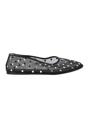 Zapato plano de malla negra con tachuelas redondas de plata que cubren la superficie y un ribete negro alrededor de la apertura.