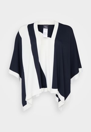 Zwart-witte poncho met brede mouwen, een V-hals en een geometrisch kleurblokontwerp. Gemaakt van een zachte, comfortabele gebreide stof.