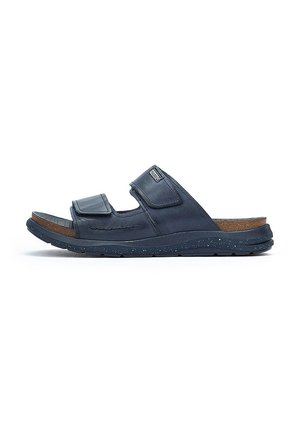 Sandales bleu marine avec deux sangles en velcro ajustables, semelle texturée, semelle intérieure en liège et semelle en caoutchouc avec paillettes.