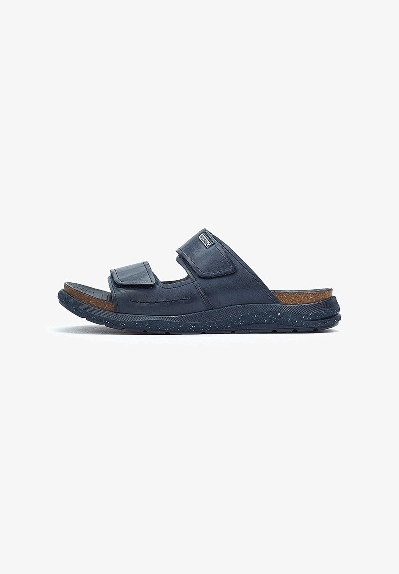 Sandales bleu marine avec deux sangles en velcro ajustables, semelle texturée, semelle intérieure en liège et semelle en caoutchouc avec paillettes.
