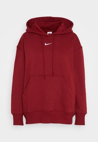 Red hoodie made of soft fabric with a kangaroo pocket, drawstring hood, and a white Nike logo on the chest. Features ribbed cuffs and hem.