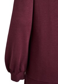 Bordeaux sweatshirt met een zachte textuur, met pofmouwen en elastische manchetten. Het ontwerp benadrukt een gladde, getailleerde silhouette.