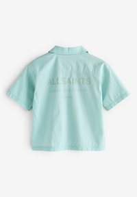 Camicia azzurro chiaro a maniche corte con colletto. Presenta la scritta "ALLSAINTS" stampata con caratteri discreti sul retro. Realizzata in morbido cotone.
