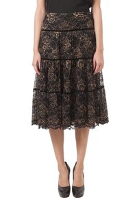 Black lace skirt with gold floral pattern, tiered design, scalloped hem, and black band accents. Worn with black heels.