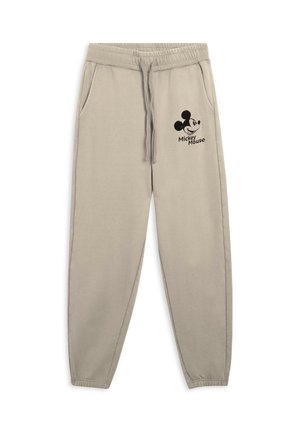 Pantaloni jogger beige realizzati in tessuto morbido, dotati di tasche laterali, elastico in vita con cordoncino e logo di Topolino nero.