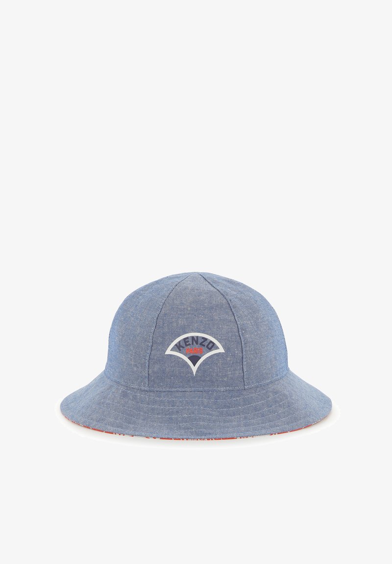 Chapeau seau en denim bleu avec un patch logo rouge et blanc à l'avant, doté d'une bande intérieure rouge contrastante. Texture douce, forme classique.