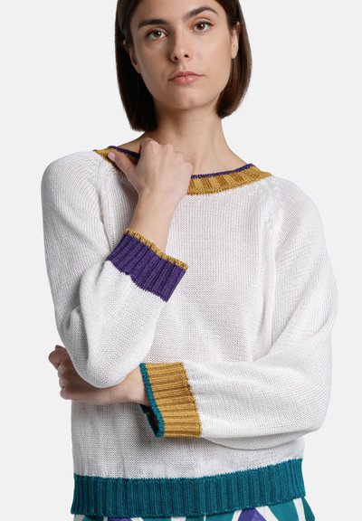 White knit sweater with ribbed edges in purple, gold, and teal. Relaxed fit and textured surface, featuring a wide crew neckline.