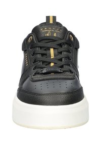 Black sneaker with a textured leather upper, perforated toe box, gold accents, round laces, and a white rubber sole. Features logo detail.