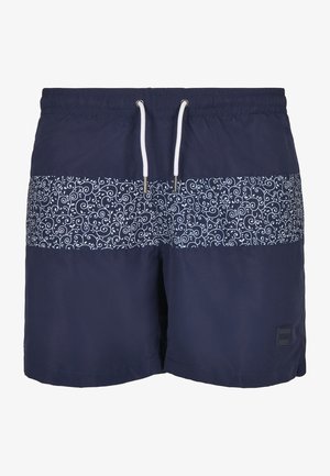 Costumi da bagno blu navy con una fascia a motivo bianco a spirale, cintura elastica e cordoncino. Presenta una piccola etichetta nera con logo sul lato.