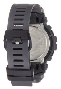Montre en plastique gris avec un bracelet texturé, présentant des sections découpées. Dossier métallique visible, conception résistante à l'eau mise en avant.