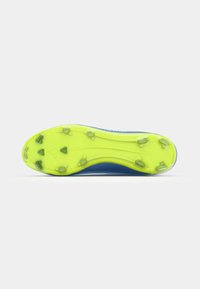 Blue cleated sports shoe sole featuring a bright yellow base with multiple green rubber studs and a smooth texture for traction.