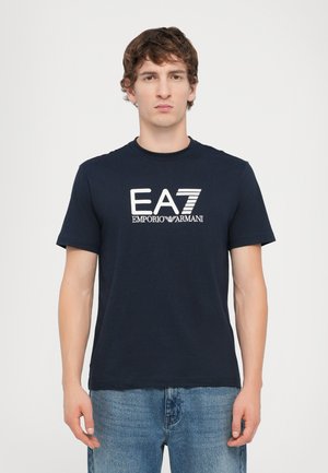 Navy blue cotton t-shirt with short sleeves, featuring an embroidered EA7 Emporio Armani logo in white across the chest.