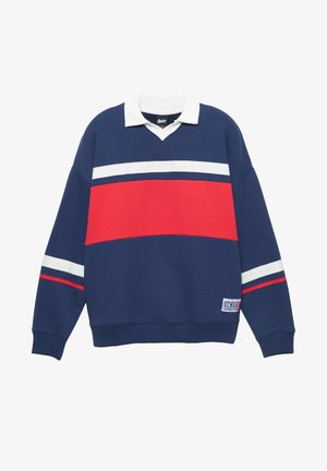 Tmavomodrá mikina s bielym golierom a červeným pruhom. Má horizontálne biele pruhy a logo nášivku na dolnej ľavej strane. Materiál z bavlnenej zmesi.