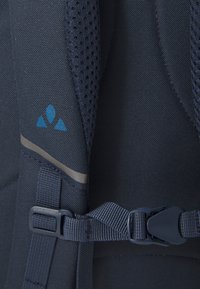 Navy backpack featuring breathable mesh, a blue logo, grey accent stripe, adjustable straps, and a plastic buckle closure.