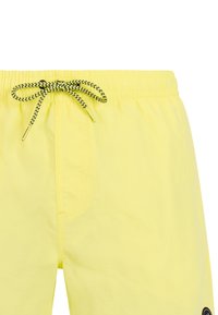 Pantaloncini gialli con vita elastica e coulisse a zigzag nero e giallo annodata sul davanti.