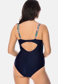 Marinblå baddräkt med blommönstrade justerbara band, nyckelhålsdetalj bak och slät yta. Designad för stil och komfort.