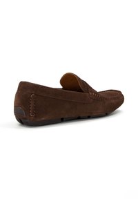 Brown suede loafer with a rounded toe, stitched detailing, and a flat rubber sole. Open back design allows for easy slip-on wear.