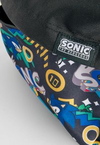 Sonic the Hedgehog-väska med svart topp, färggrafisk tryck som visar en blå igelkott, ringar och mönster på slitstarkt tyg.