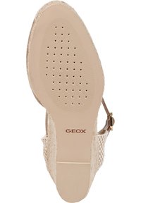 Beige Geox sandal featuring a textured, breathable upper with a woven pattern, a brown sole with perforations, and a metallic buckle detail.