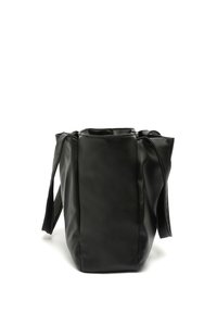 Black leather tote bag with textured exterior, open top, sturdy handles, and structured shape. Minimalist design, no visible embellishments.