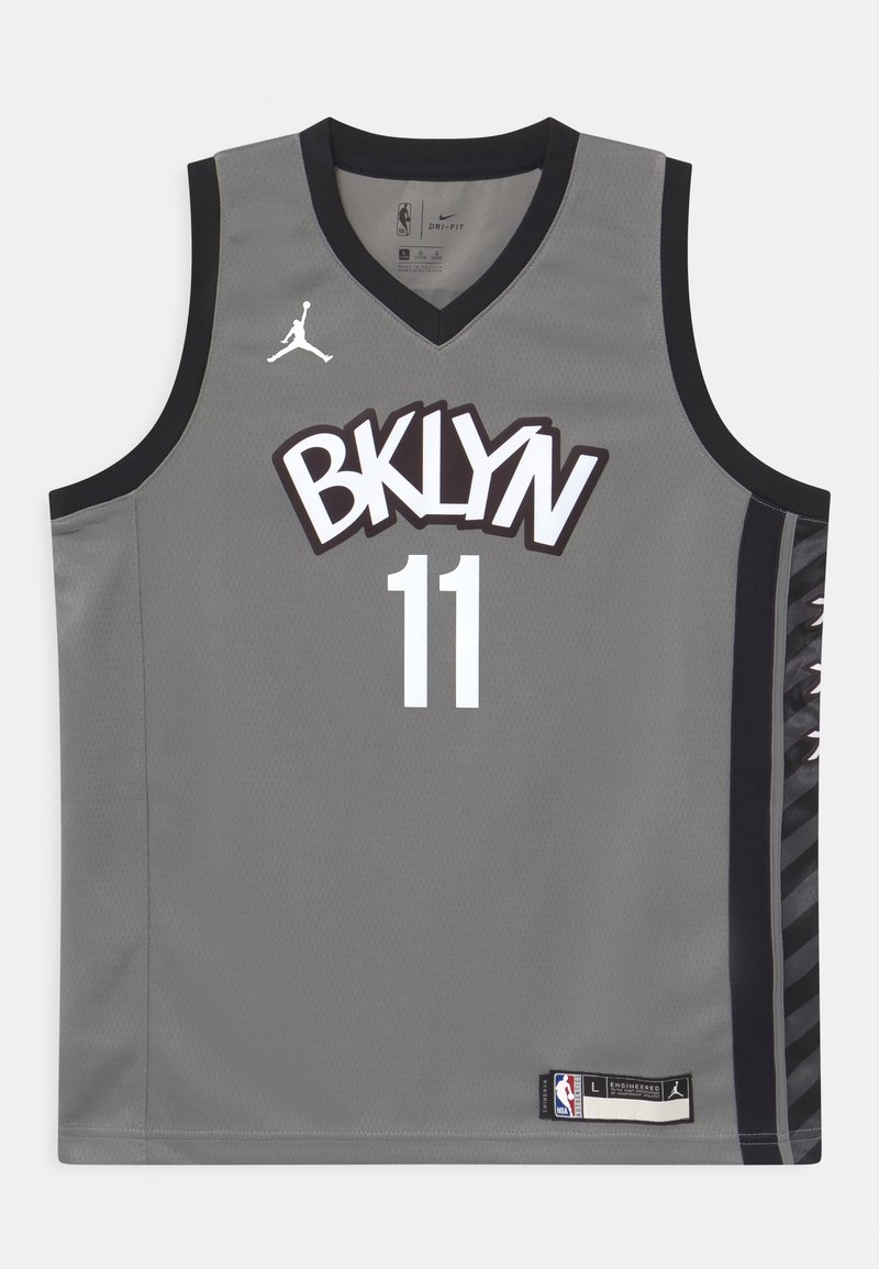 Jersey de baloncesto gris con acentos negros, impresión de "BKLYN", número 11 en blanco, tejido de malla y marca Nike en el cuello y el dobladillo.