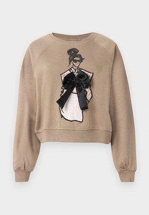 Beige cropped sweatshirt featuring a graphic design of a woman in a dress, with a black satin bow accent and textured details.