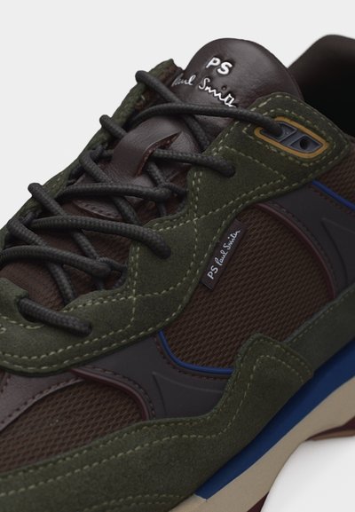 Baskets en daim vert foncé et marron avec lacets noirs, panneaux en mesh, accents bleus sur la semelle, et logo "PS Paul Smith" sur la languette et l'étiquette latérale.
