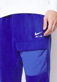 Nike Sportswear AIR WINTER PANT - Cargo trousers - deep royal blue/white