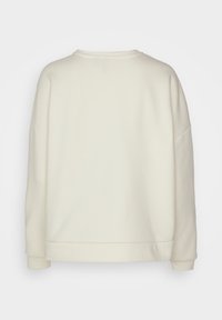 Light beige sweatshirt with a relaxed fit, ribbed crew neck, and long sleeves. Smooth texture and no visible patterns or hardware.