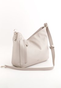 Beige nahkakäsilaukku, jossa on rento muotoilu. Laukussa on etupuolella vetoketjutasku, säädettävä olkahihna ja minimaliset metallikoristeet.