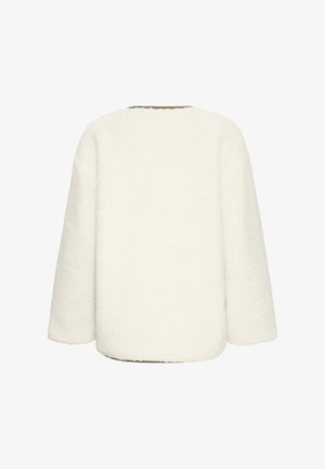 Veste en polaire surdimensionnée couleur crème avec une surface texturée, des épaules tombantes et un ourlet arrondi, sans fermetures visibles.