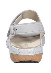 Light gray sandals with a wide strap, buckle closure, and textured silver accent detail on a cork-like sole. Soft, cushioned footbed.