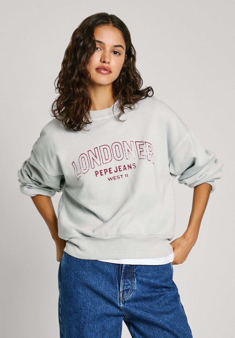 Šviesiai pilkas džemperis su užrašu „LONDONER PEPE JEANS WEST II“ bordo spalva, laisvas kirpimas, nuleistos pečių linijos ir gumbai ant rankovių.