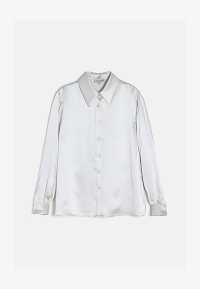 Chemise en satin blanc à manches longues, boutonnée, avec col large et pointu et poignets boutonnés, présentée sur un fond uni.