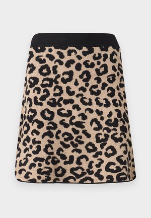 Jupe en imprimé léopard avec taille noire, fond beige et taches noires irrégulières, présentée à plat sur un fond blanc.