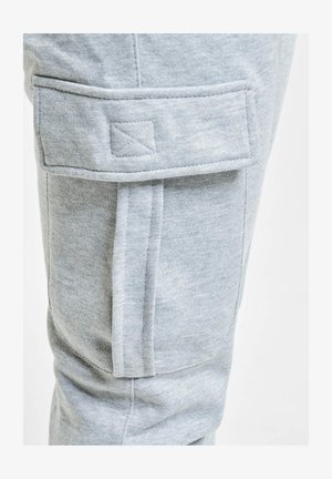 Gray cotton cargo pants featuring a patch pocket on the thigh with stitched detailing. Soft texture, tapered fit, and no visible hardware.