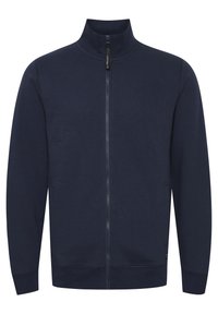 Marineblå zip-up hettegenser med høy krage, ribbestrikkede mansjetter og sidelommer. Laget av mykt, teksturert stoff med en glatt glidelås.